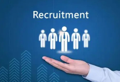 A businessman's hand supporting a group of stylised human icons, representing a professional recruitment process, with the word 'Recruitment' displayed above on a blue background.